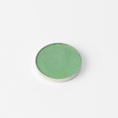 Pressed eyeshadow pan, bright green shimmer finish