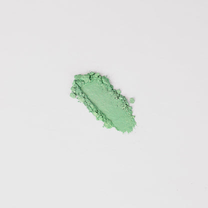 Pressed eyeshadow swatch, bright green textured sparkle