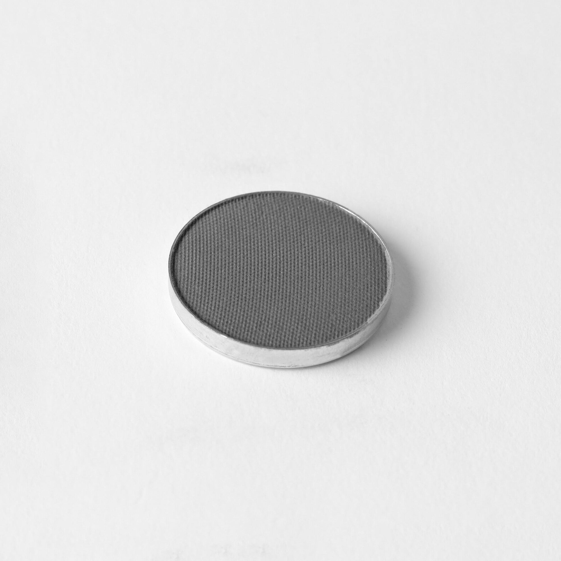 Pressed eyeshadow pan in charcoal gray shimmer
