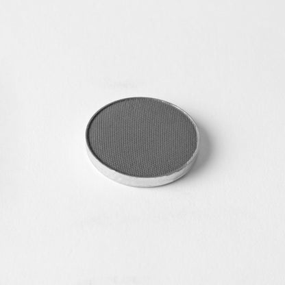 Pressed eyeshadow pan in charcoal gray shimmer