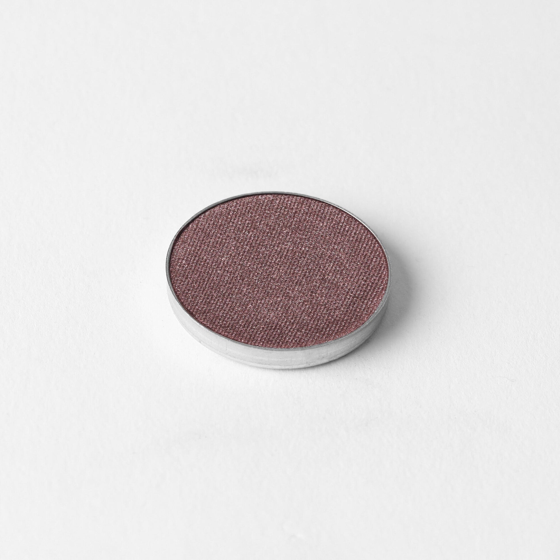 Pressed eyeshadow pan, shimmering plum-mauve