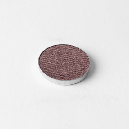 Pressed eyeshadow pan, shimmering plum-mauve