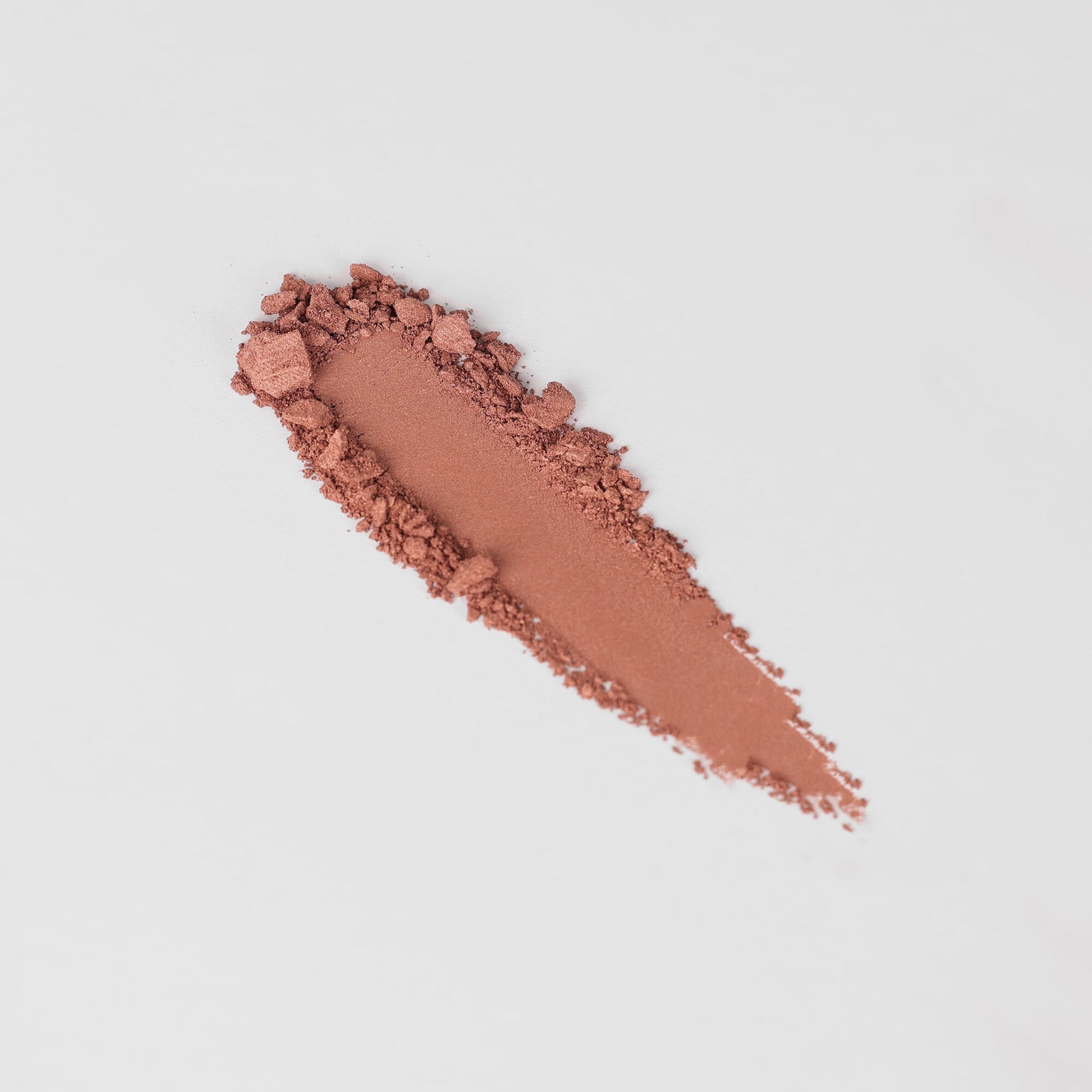 Pressed eyeshadow swatch strip in warm rose-brown shimmer powder