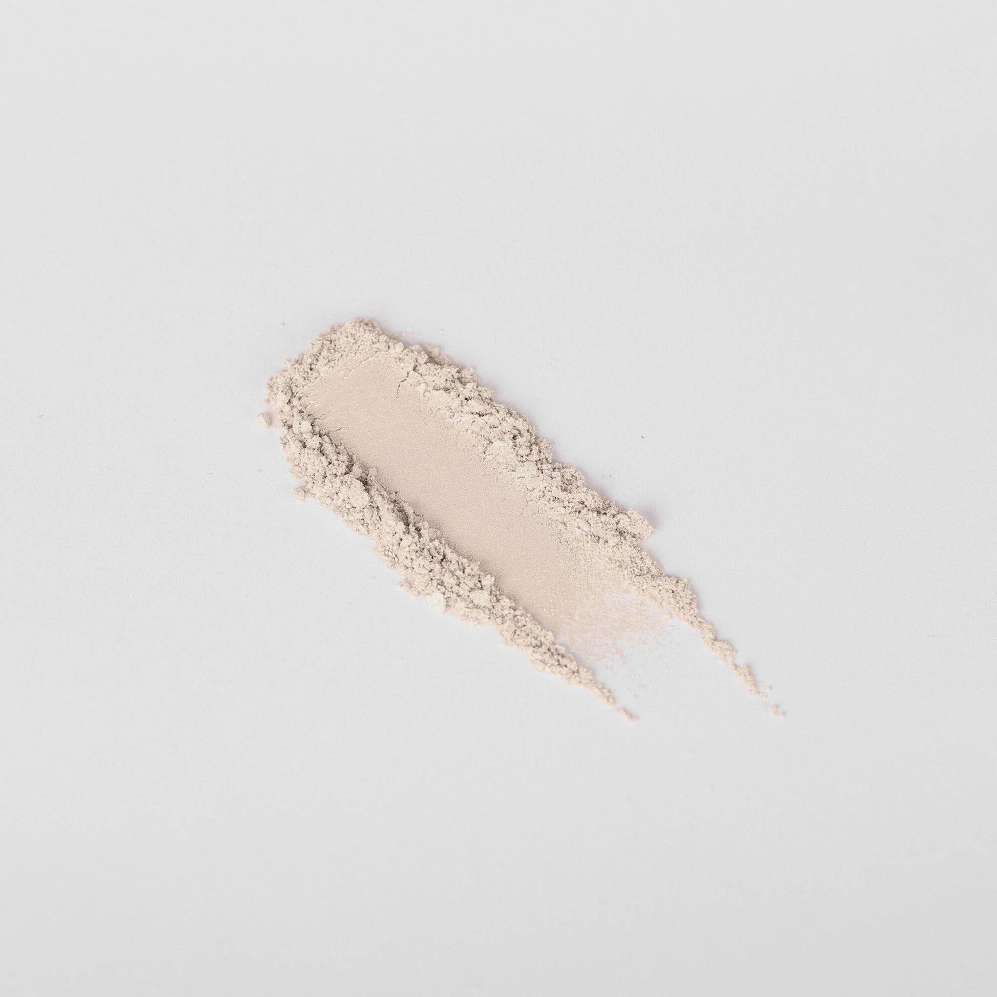 Swatch of pale beige-pink pressed eyeshadow with shimmer