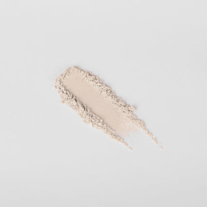 Swatch of pale beige-pink pressed eyeshadow with shimmer