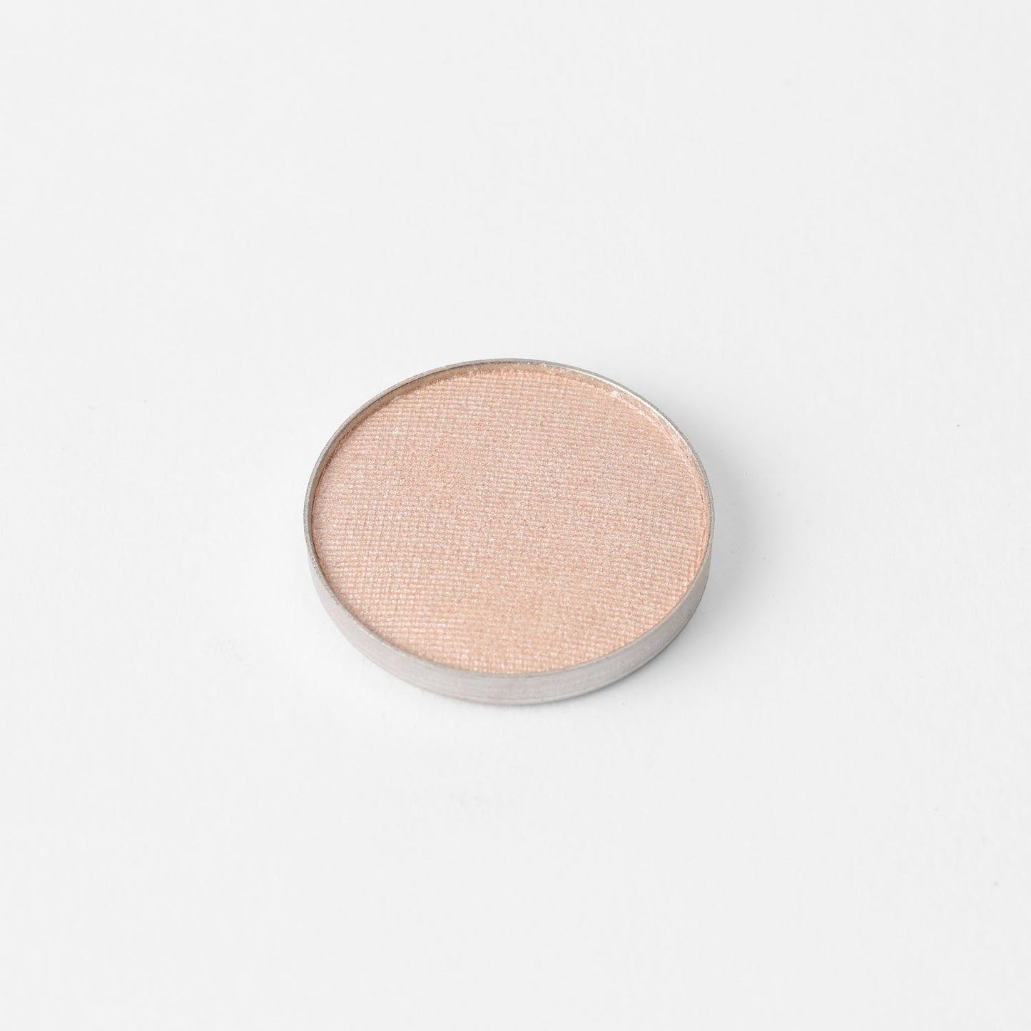 Pressed eyeshadow pan, light pink-peach shimmer