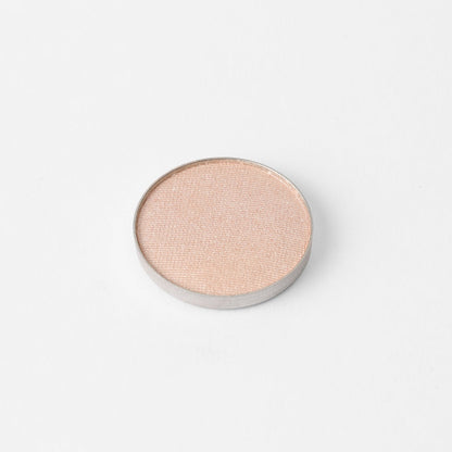 Pressed eyeshadow pan, light pink-peach shimmer