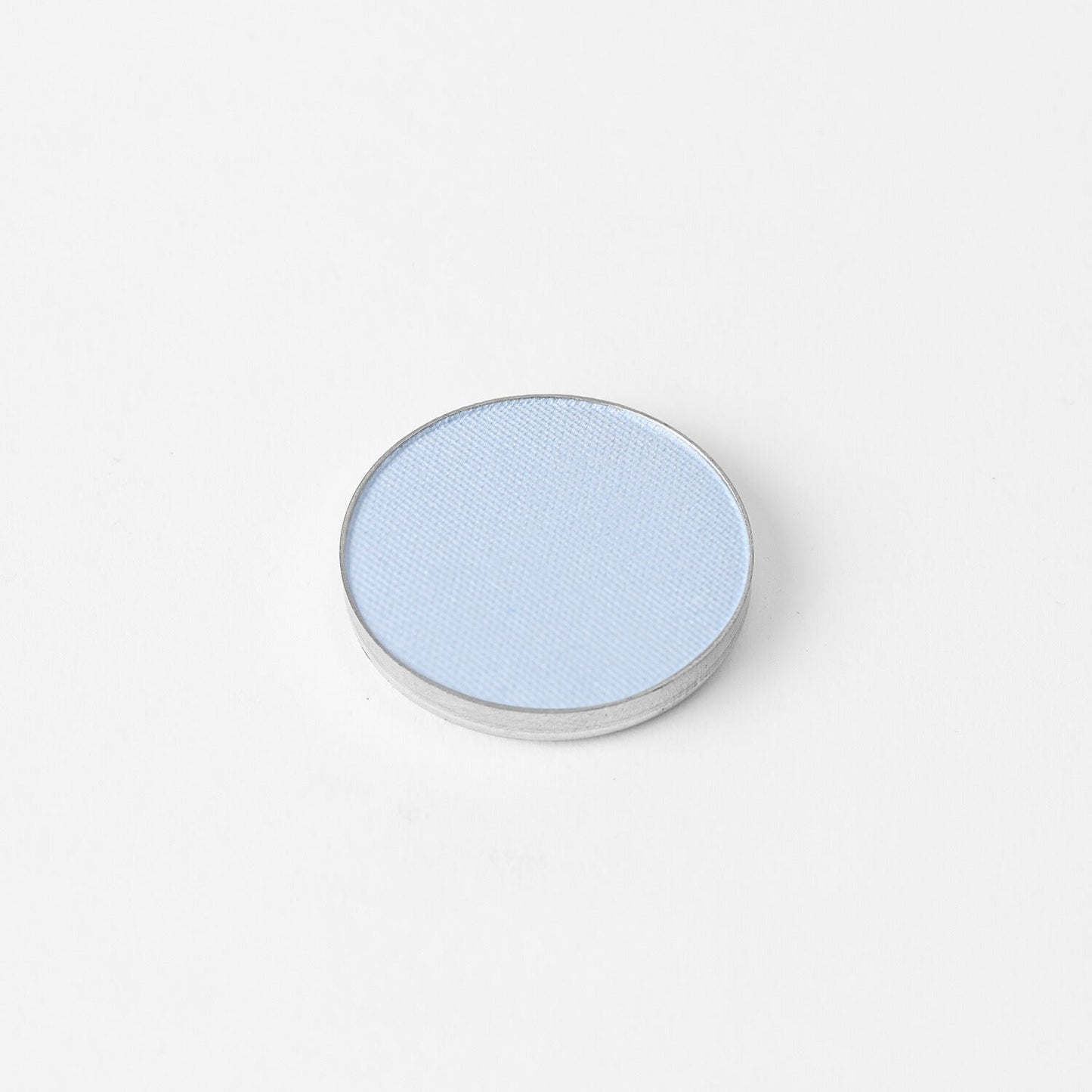 Pressed eyeshadow pan, light blue shimmer finish