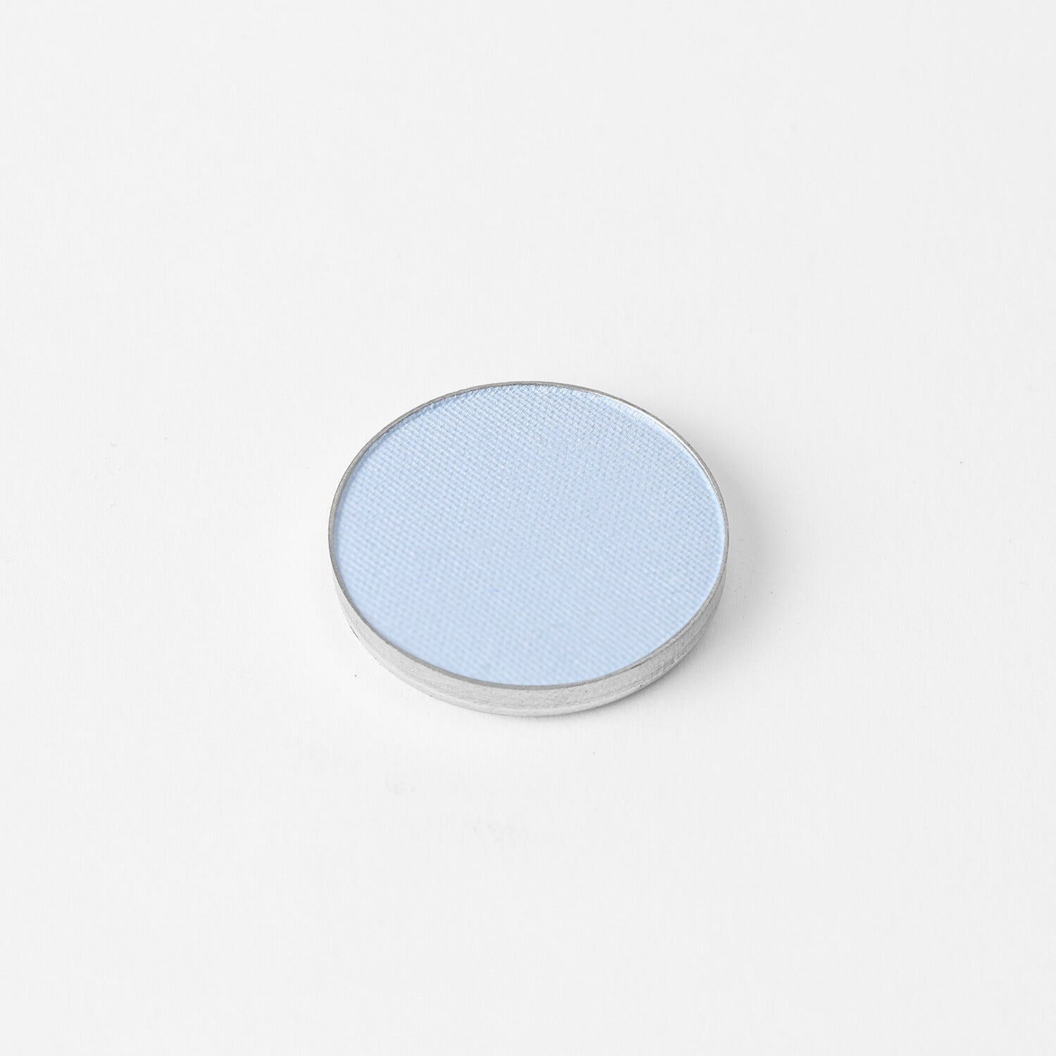 Pressed eyeshadow pan, light blue shimmer finish