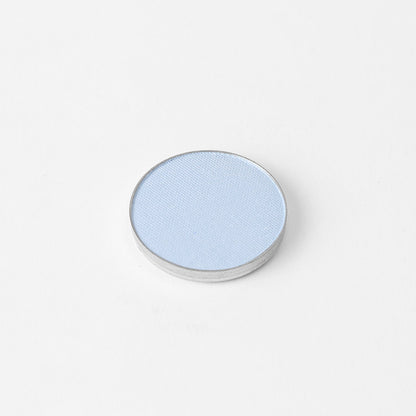 Pressed eyeshadow pan, light blue shimmer finish