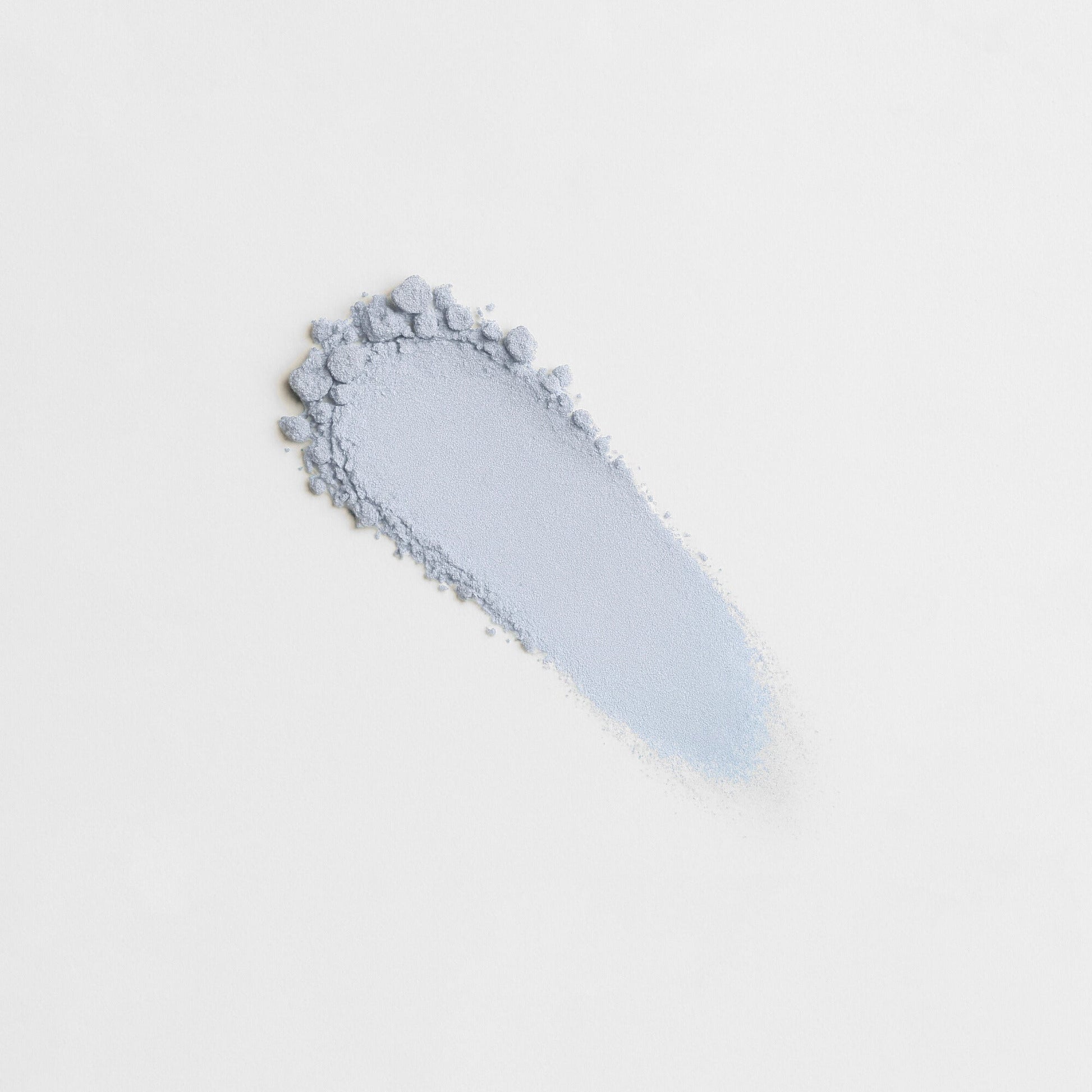 Pressed eyeshadow with light blue, shimmery powder and textured swatch edge
