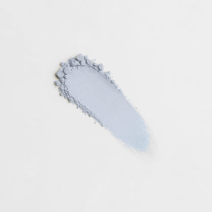 Pressed eyeshadow with light blue, shimmery powder and textured swatch edge