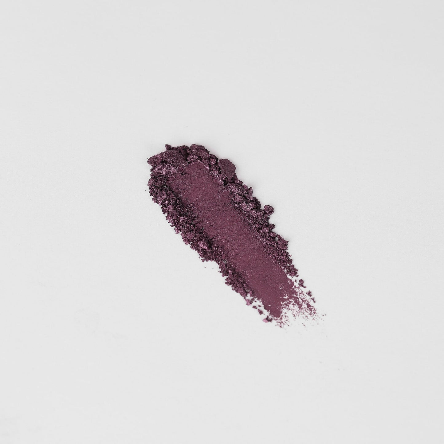 Shimmering plum-purple eyeshadow swatch on skin