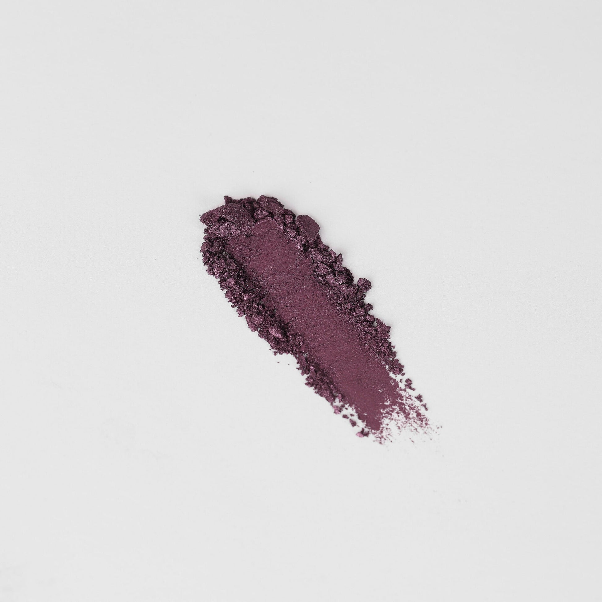 Shimmering plum-purple eyeshadow swatch on skin