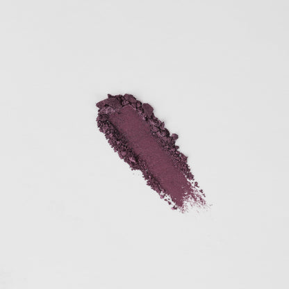Shimmering plum-purple eyeshadow swatch on skin