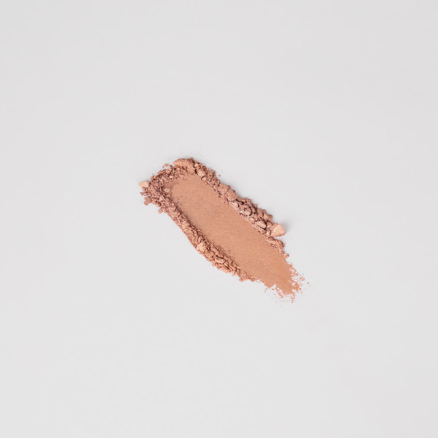 Swatch of warm peach pressed eyeshadow, elongated stripe