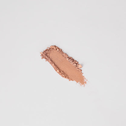 Swatch of warm peach pressed eyeshadow, elongated stripe