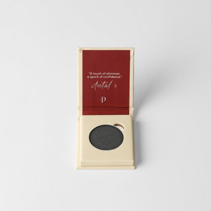 Pressed eyeshadow pan with charcoal dark shimmer, in open case