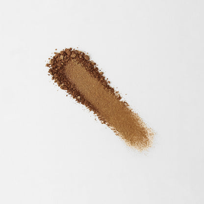 Pressed eyeshadow swatch in deep bronze-brown shimmer with scattered particles
