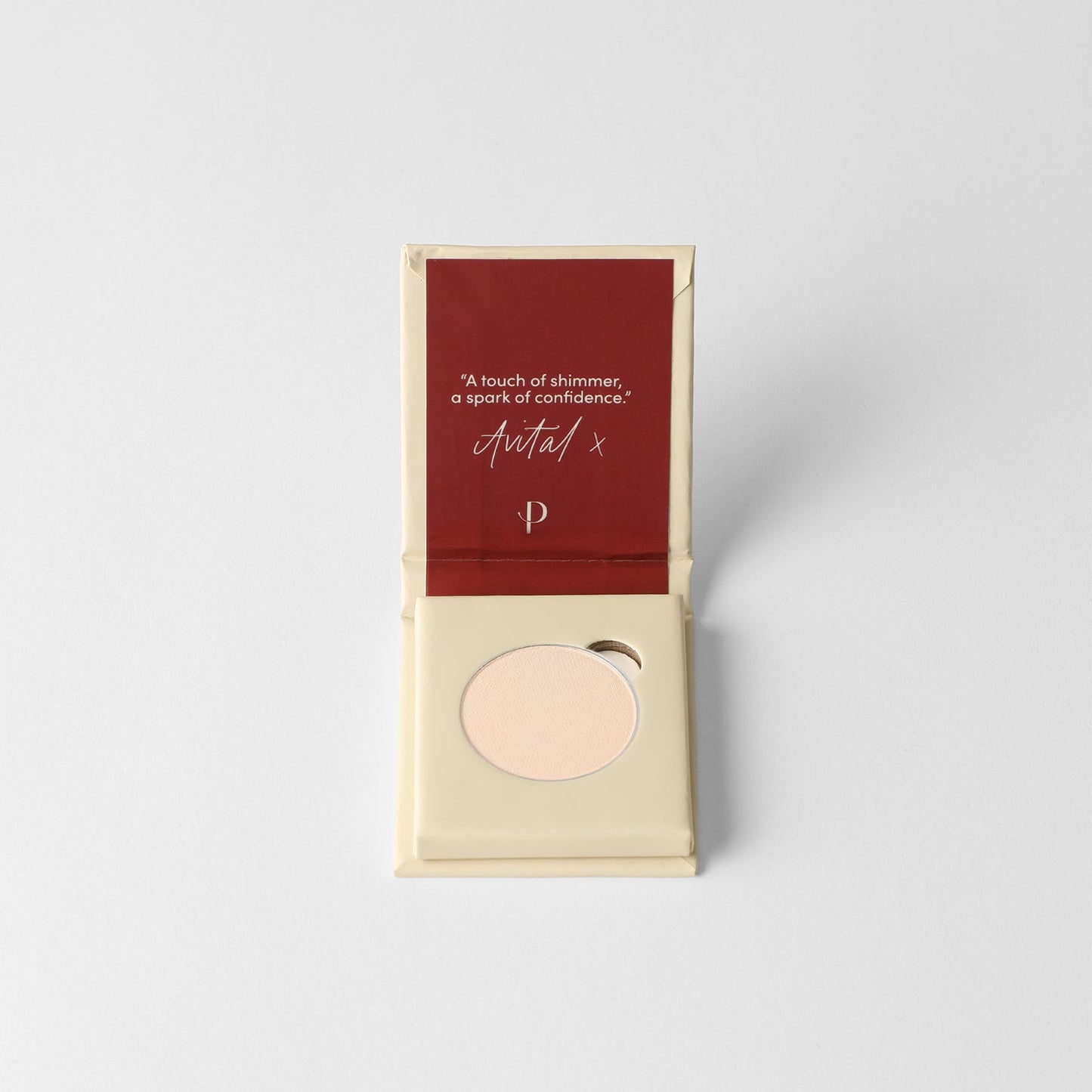 Glow pressed eyeshadow in box, with a pale pink round pan visible