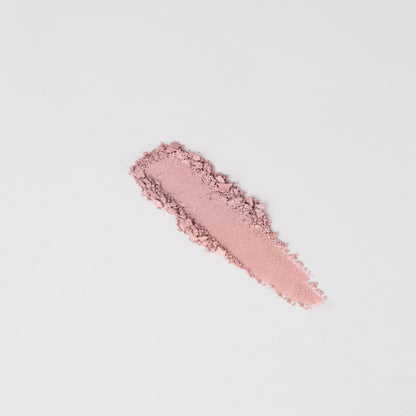 Swatch of soft pink pressed eyeshadow, elongated stripe
