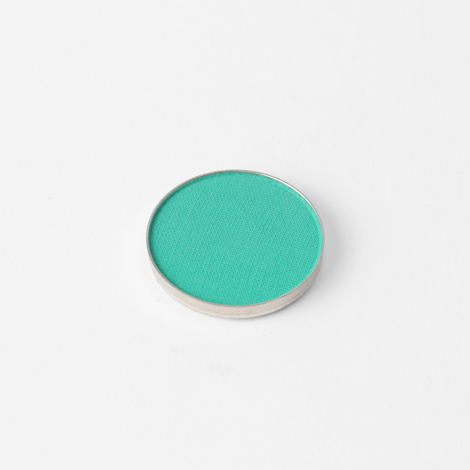 Pressed eyeshadow compact with bright green-teal oval pan