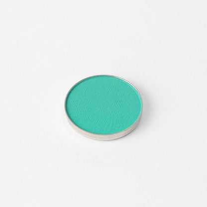 Pressed eyeshadow compact with bright green-teal oval pan
