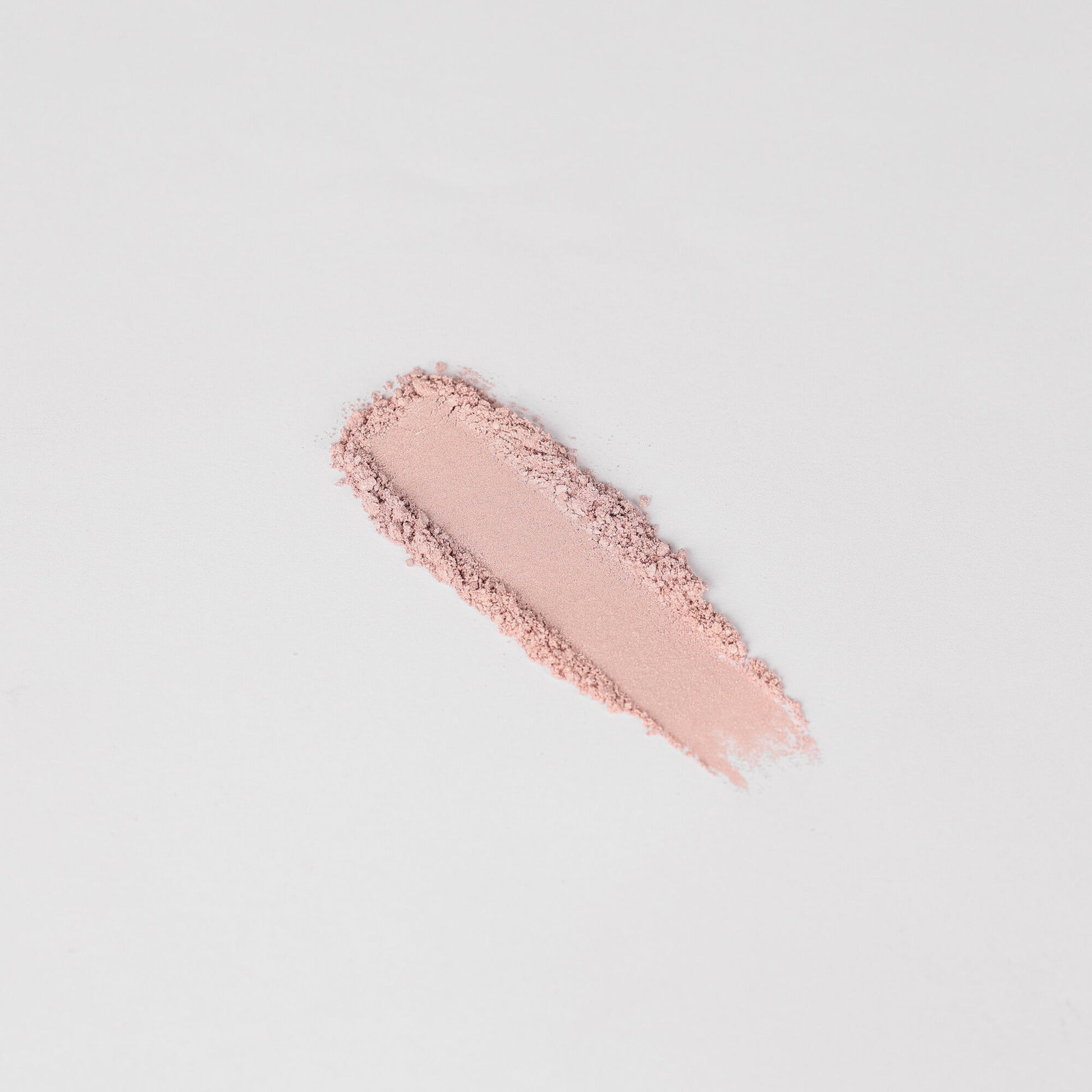 Pink shimmer eyeshadow swatch stripe with visible powder texture.