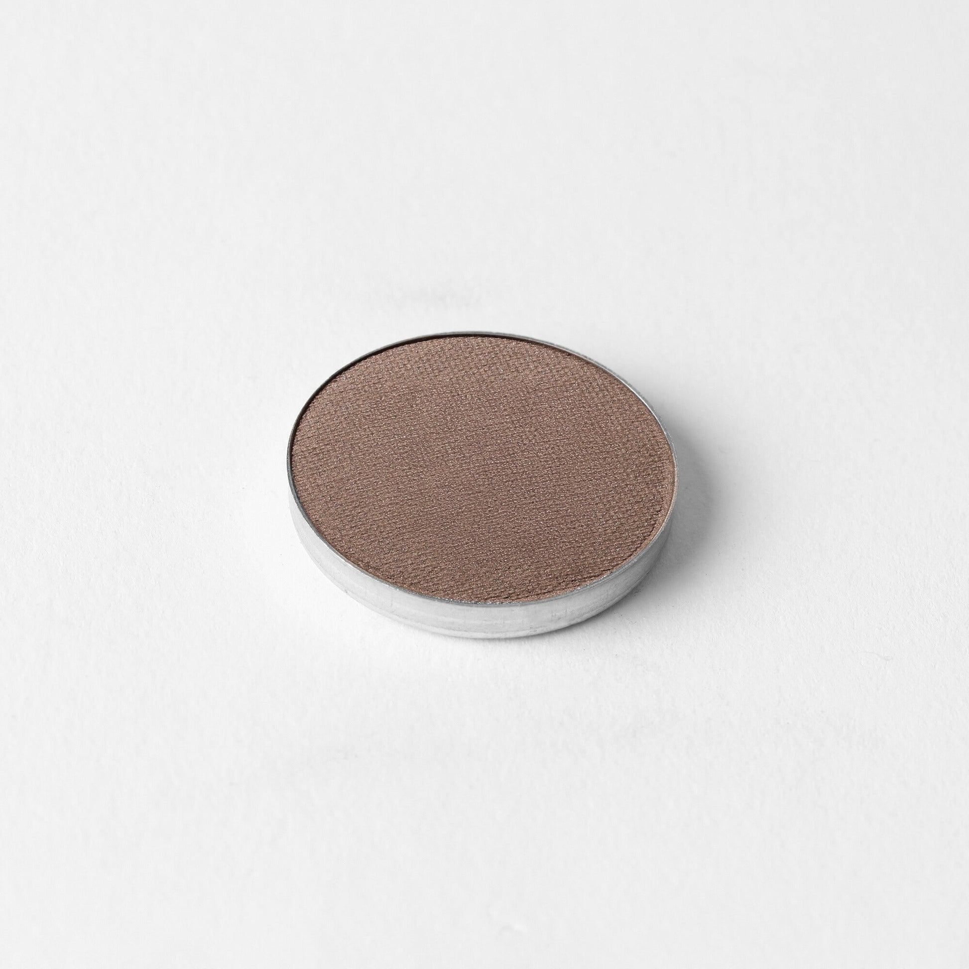 Pressed eyeshadow pan with deep taupe brown shimmer in a round compact