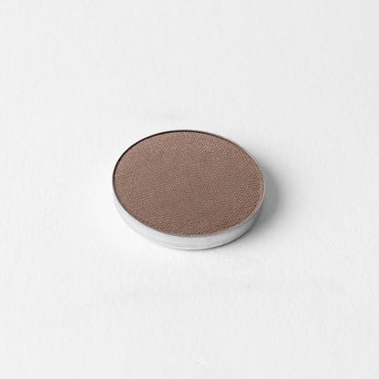 Pressed eyeshadow pan with deep taupe brown shimmer in a round compact