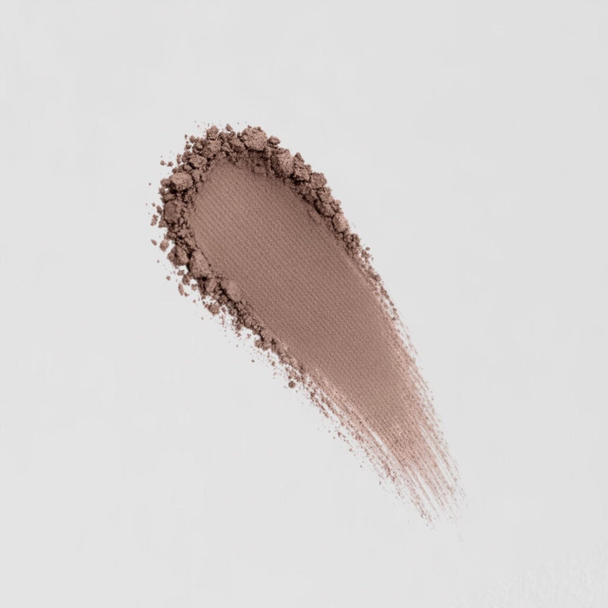 Pressed eyeshadow swatch in cool taupe brown with glittery powder fallout
