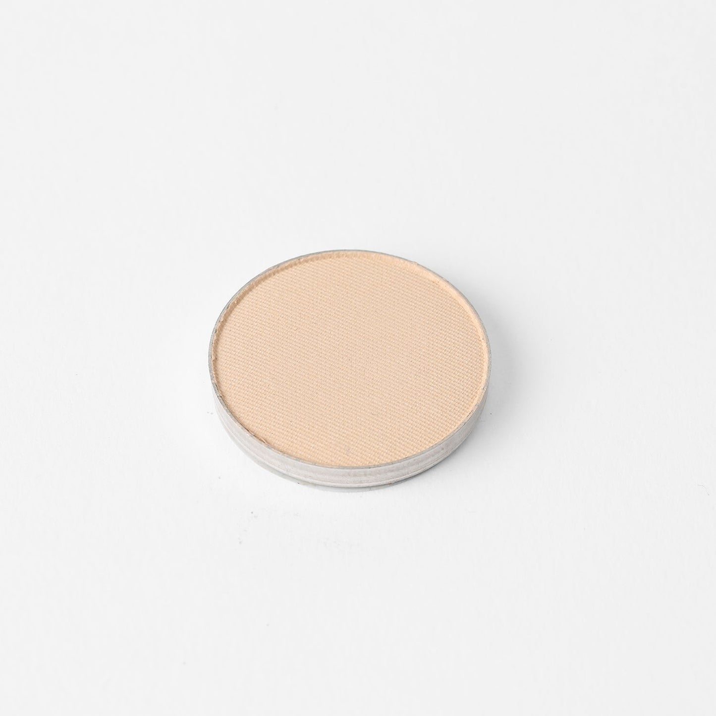 Pressed eyeshadow pan, light beige shimmer finish