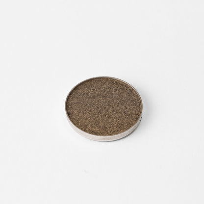 Pressed eyeshadow pan in bronze brown shimmer