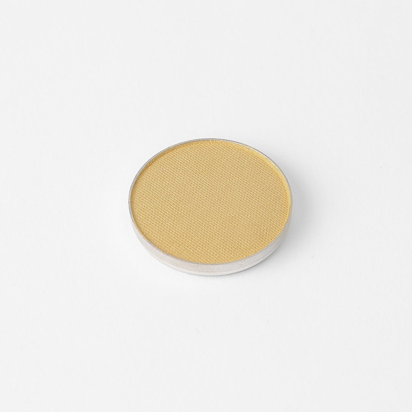 Pressed eyeshadow pan, light golden yellow