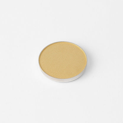 Pressed eyeshadow pan, light golden yellow