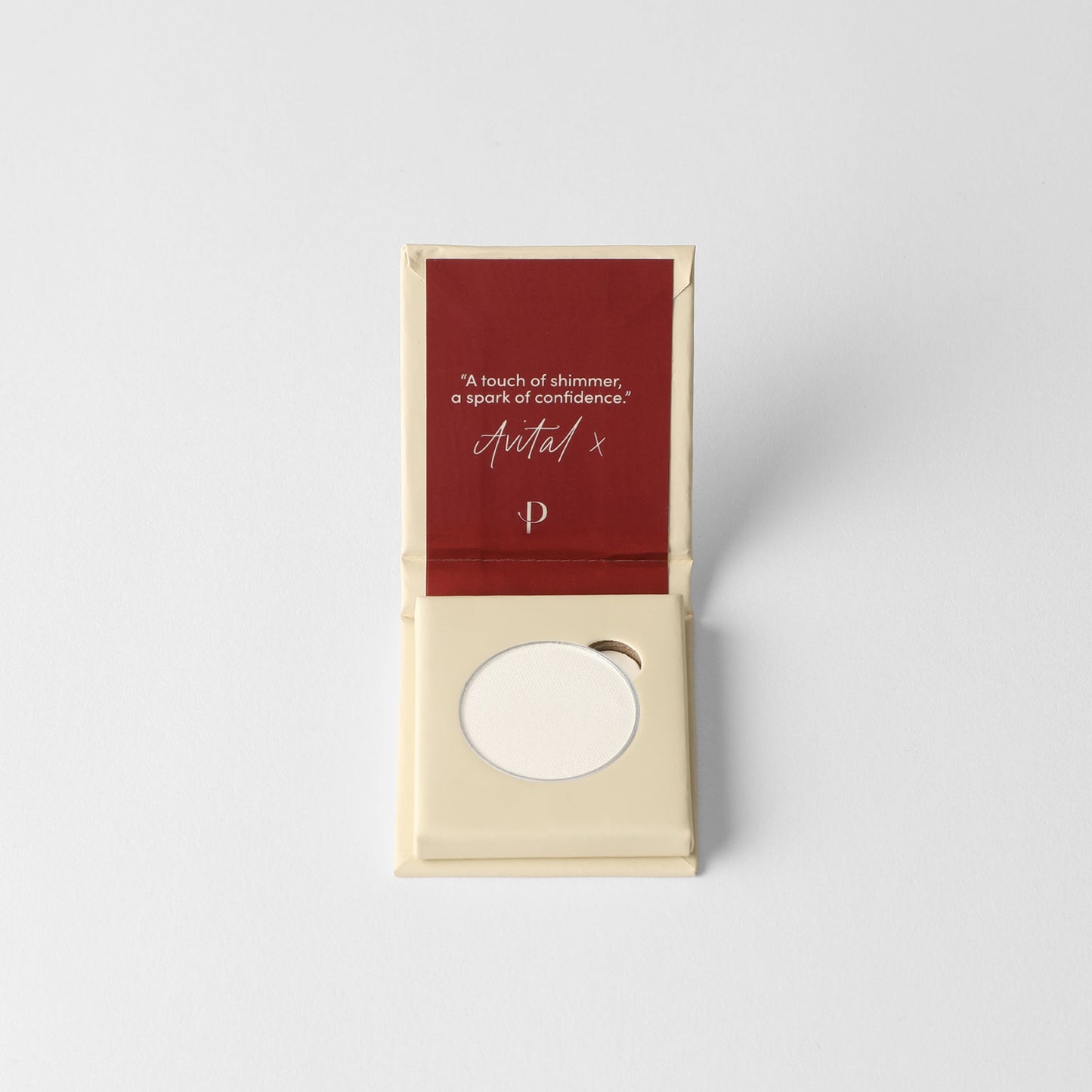 Glow pressed eyeshadow compact in box, featuring a pale pink shimmer pan