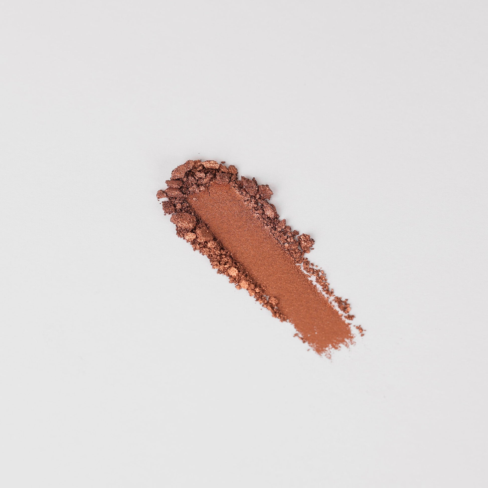 Pressed eyeshadow swatch strip in deep coppery brown shimmer powder