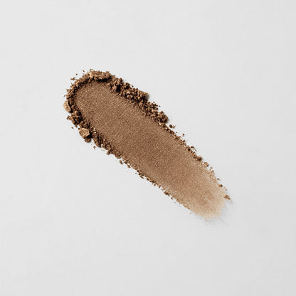 Pressed eyeshadow swatch in warm bronze brown with visible powder texture.