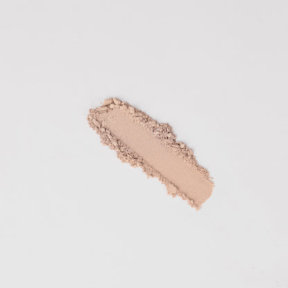 Peach nude shimmer eyeshadow swatch stripe with powdery texture.