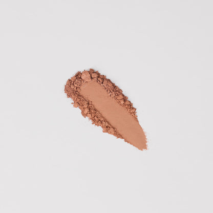 Pressed eyeshadow swatch strip in soft peachy brown shimmer powder