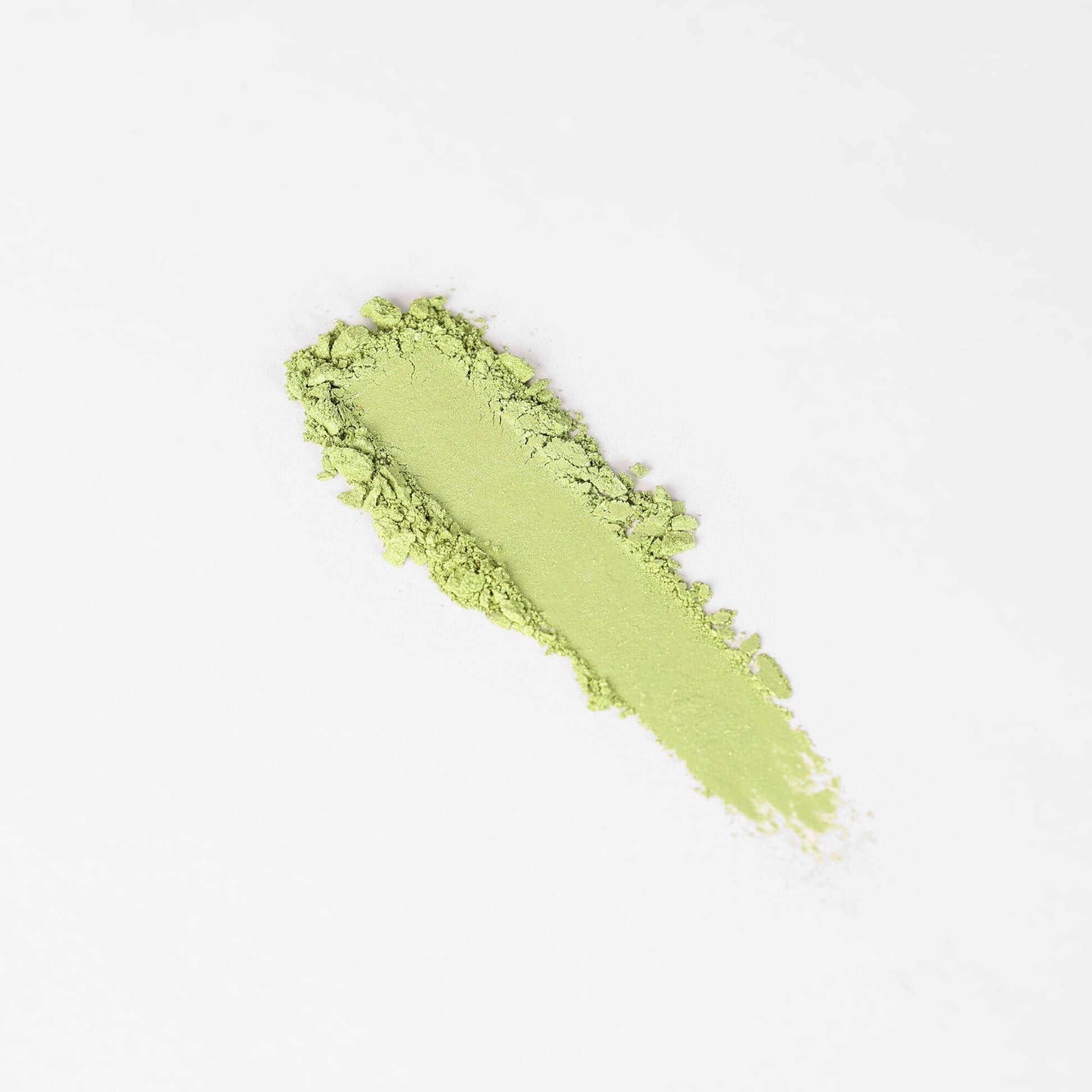 Pressed eyeshadow swatch in vivid lime green with soft, powdery edges.