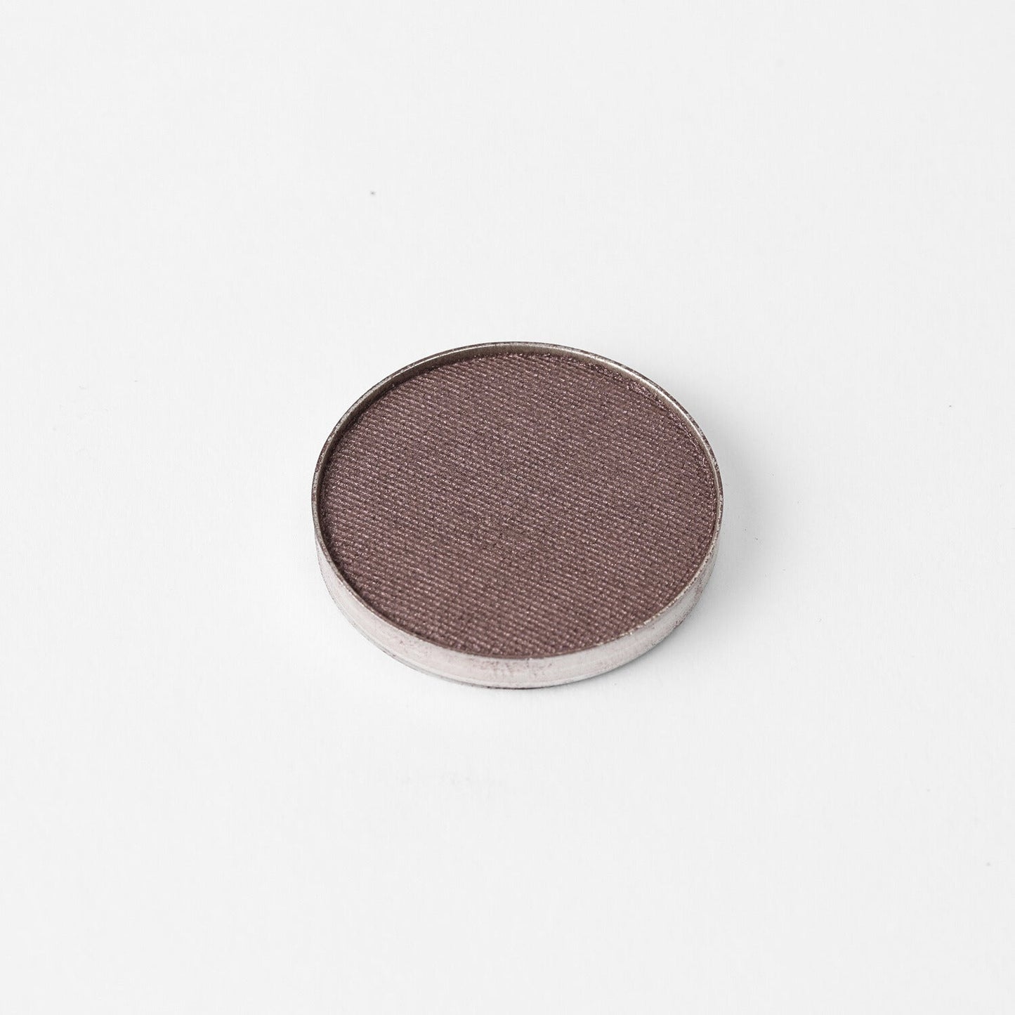 Pressed eyeshadow pan with a taupe-brown shimmer finish in a round case