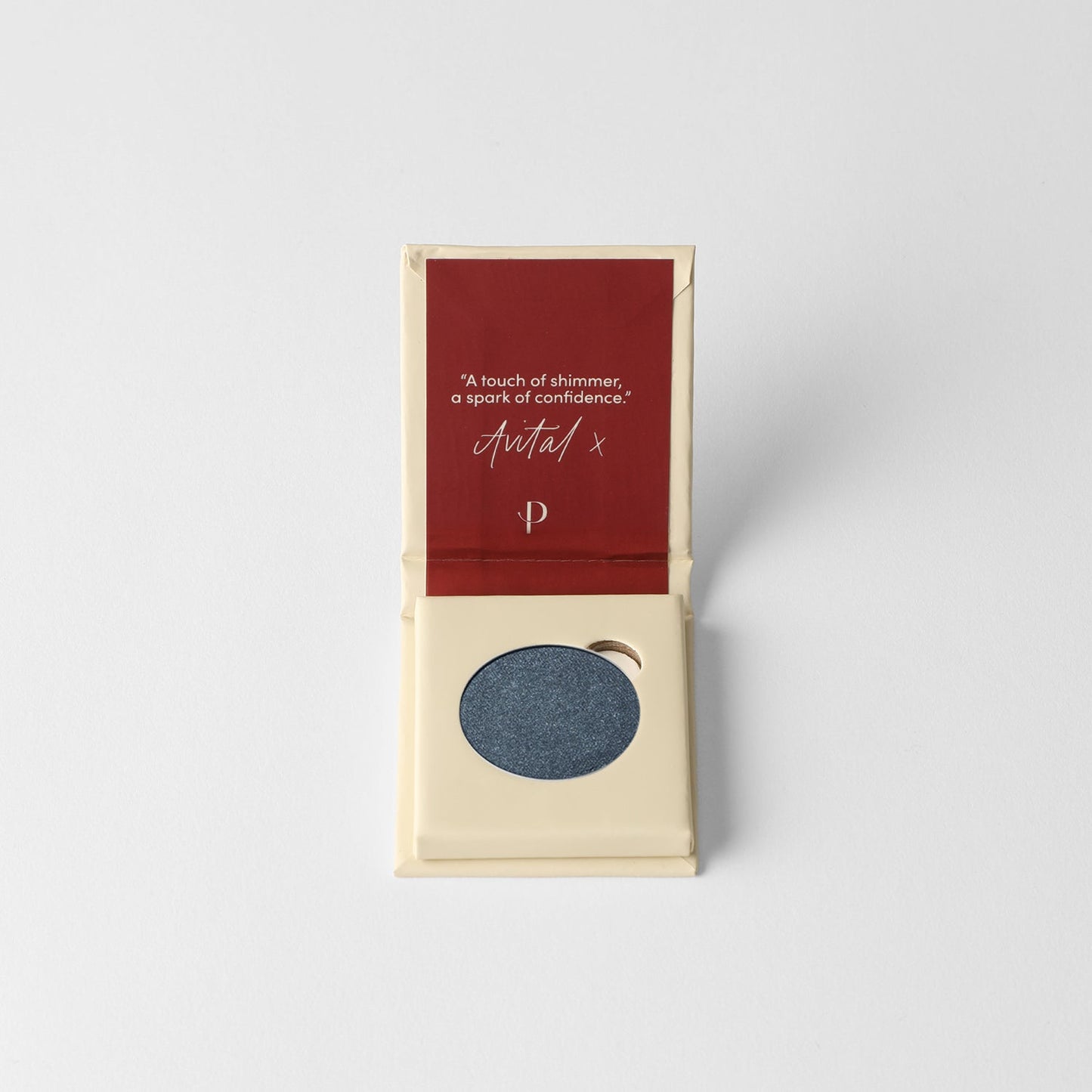 Pressed eyeshadow box with a dark blue eyeshadow pan inside.
