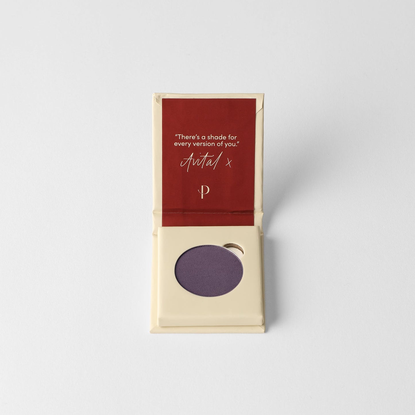 Pressed eyeshadow compact with muted purple matte pan in open box.