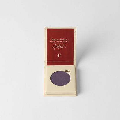 Pressed eyeshadow compact with muted purple matte pan in open box.