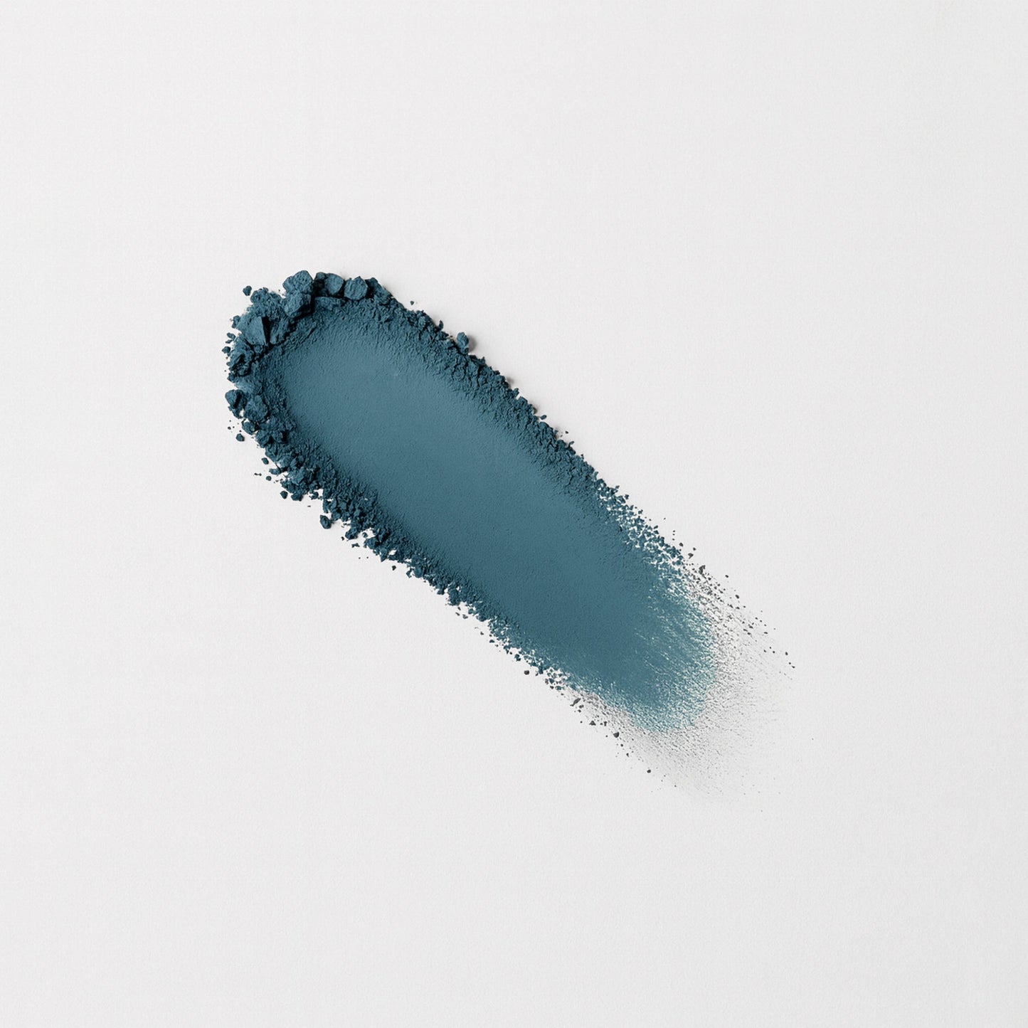 Matte pressed eyeshadow swatch, teal-blue matte powder on surface.