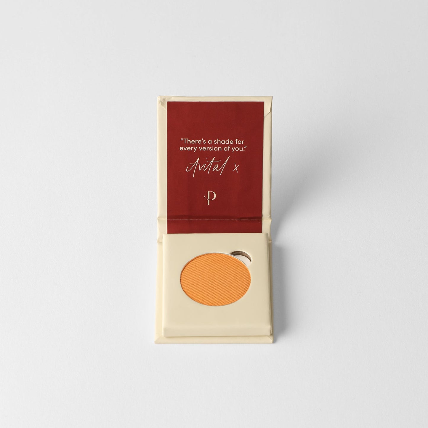 Matte pressed eyeshadow pan in box, warm orange shade