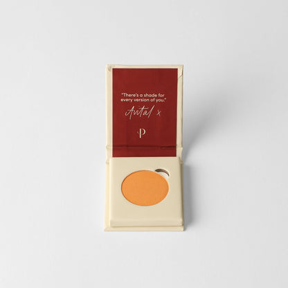 Matte pressed eyeshadow pan in box, warm orange shade