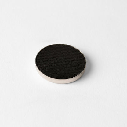 Pressed eyeshadow pan, black matte powder.