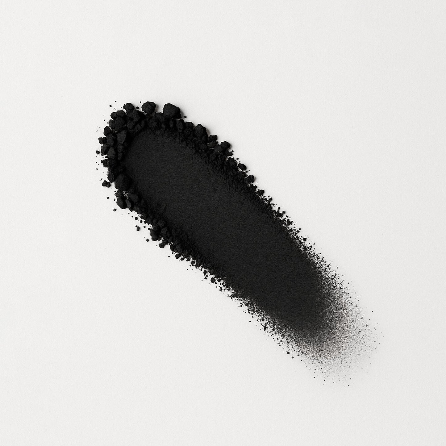 Matte pressed eyeshadow swatch, black matte powder on surface.
